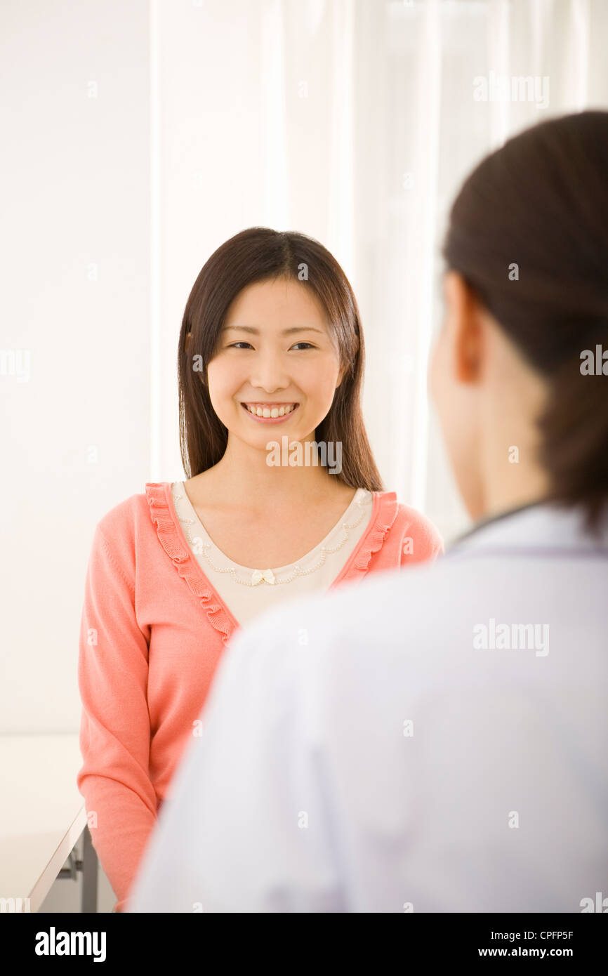 Young woman talking to female doctor Stock Photo - Alamy