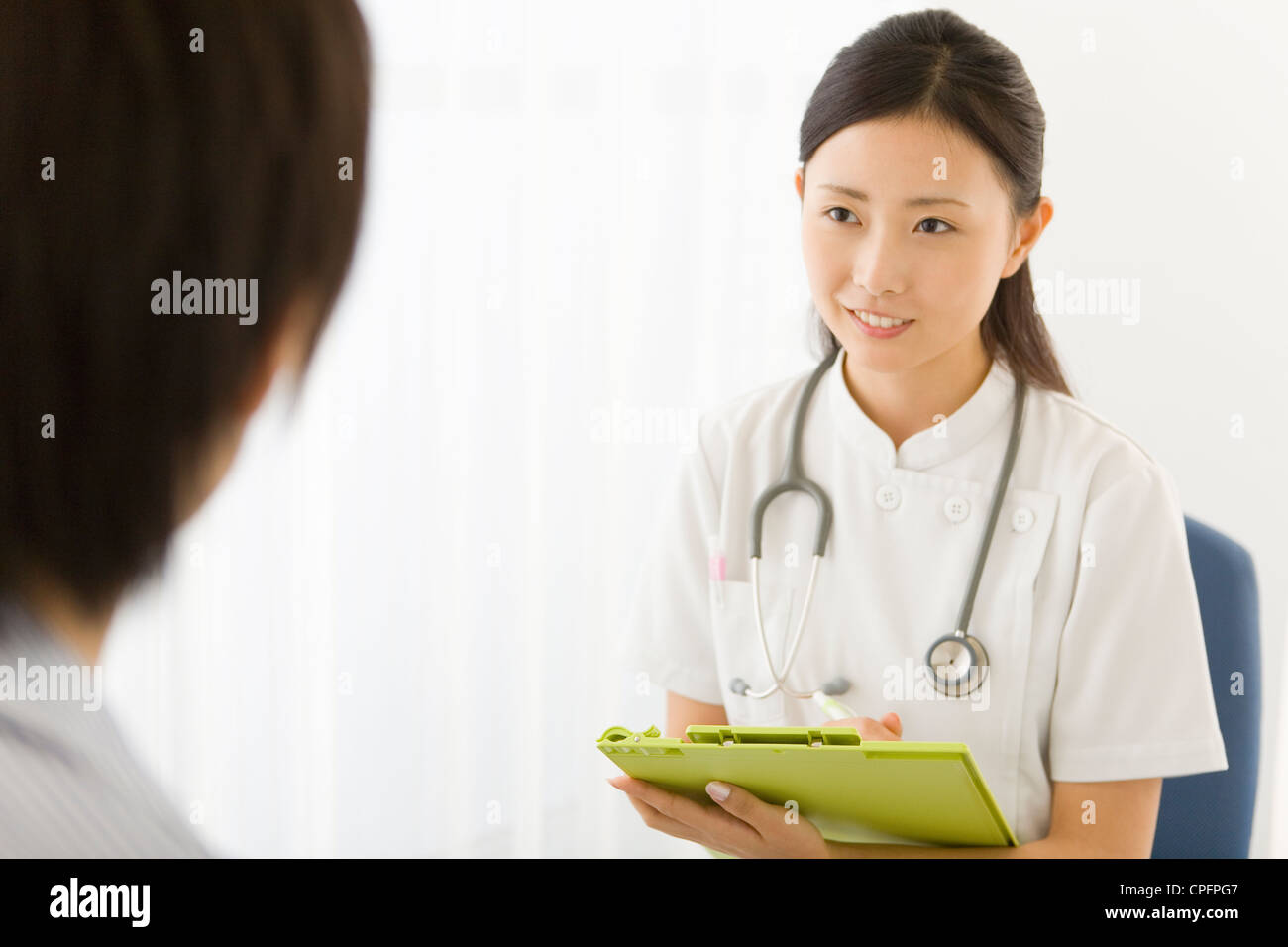 Female doctor talking to patient Stock Photo - Alamy