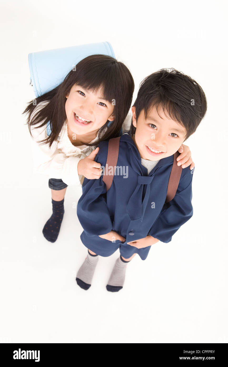Girl holding boy's shoulder Stock Photo Alamy