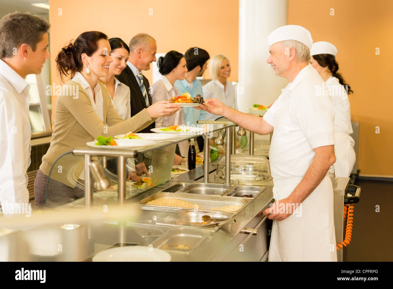 Business colleagues in cafeteria cook serve fresh healthy food meals
