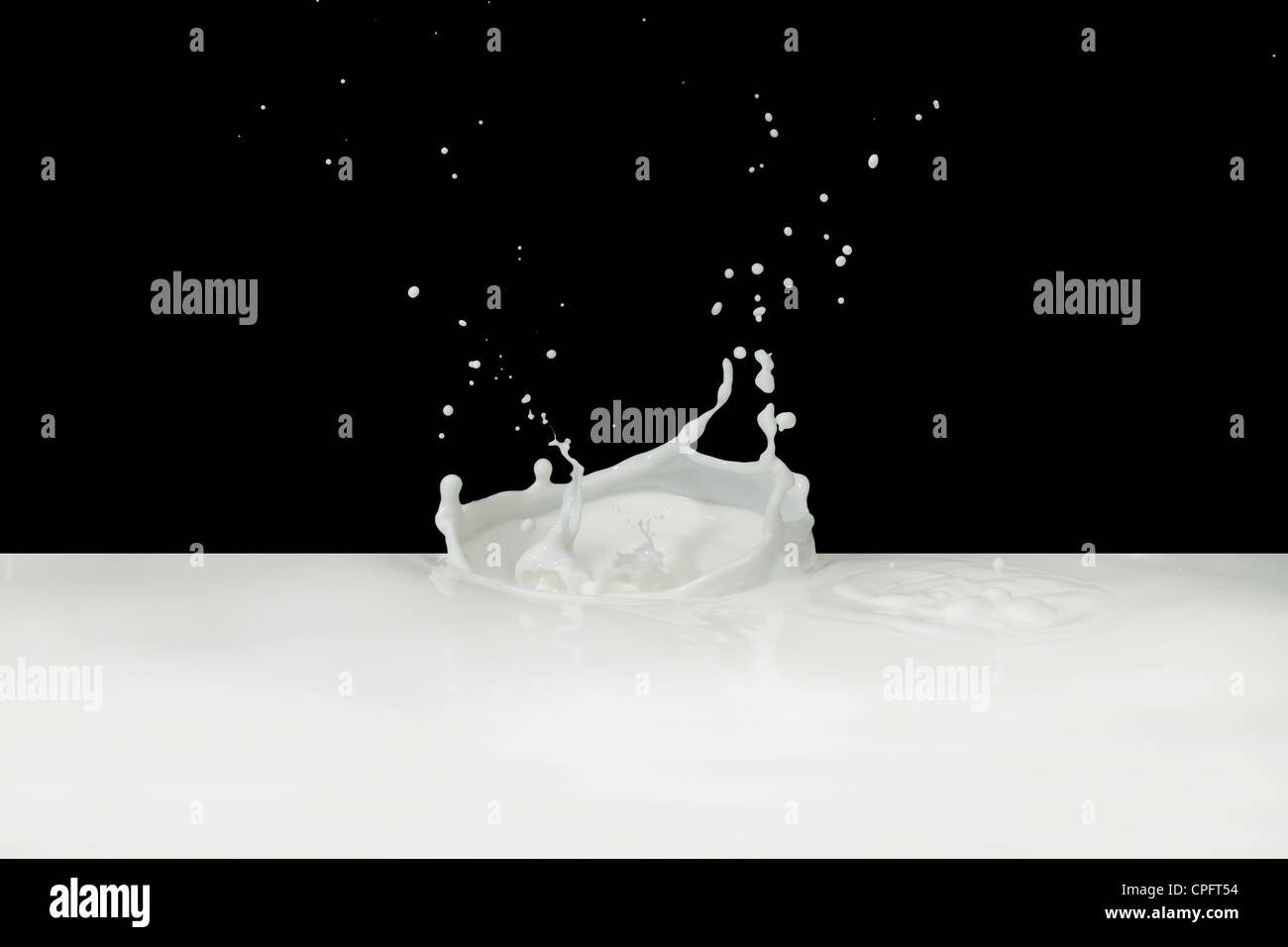splashing milk isolated on black background Stock Photo - Alamy