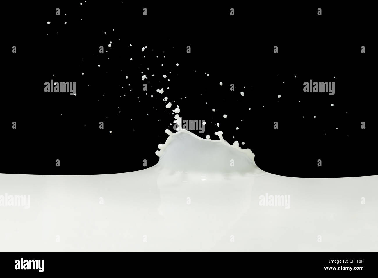 splashing milk isolated on black background Stock Photo - Alamy