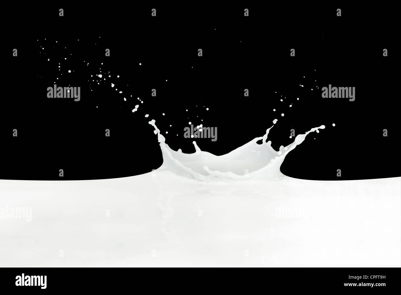 splashing milk isolated on black background Stock Photo - Alamy