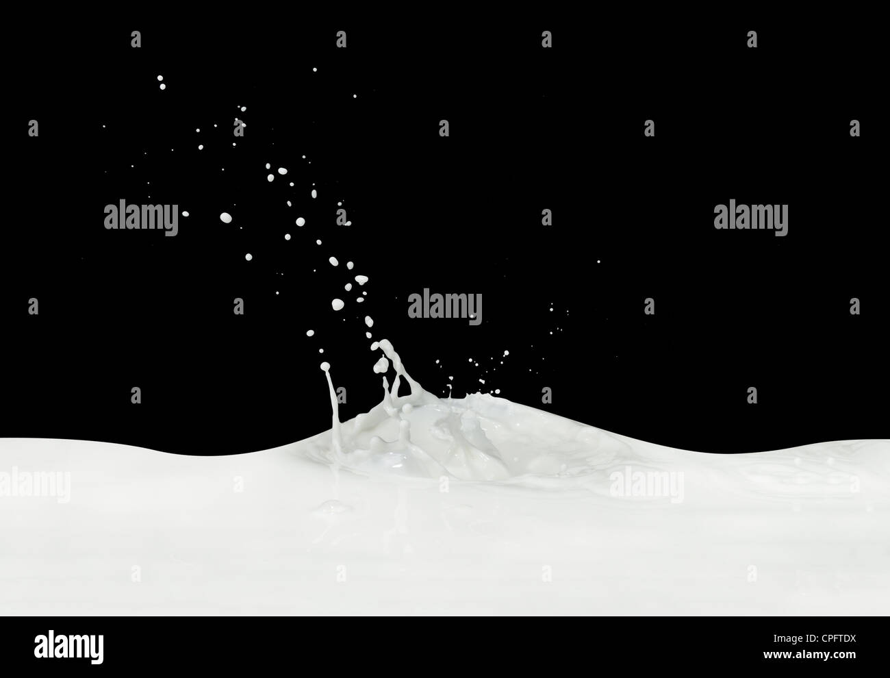 splashing milk isolated on black background Stock Photo - Alamy