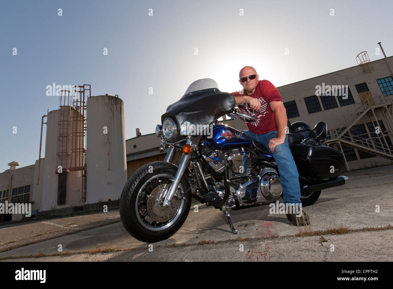 A Harley Davidson motorcyclist sitting on his bike Stock Photo