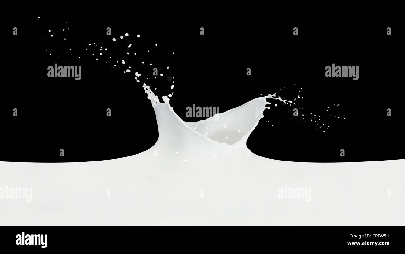 splashing milk isolated on black background Stock Photo - Alamy