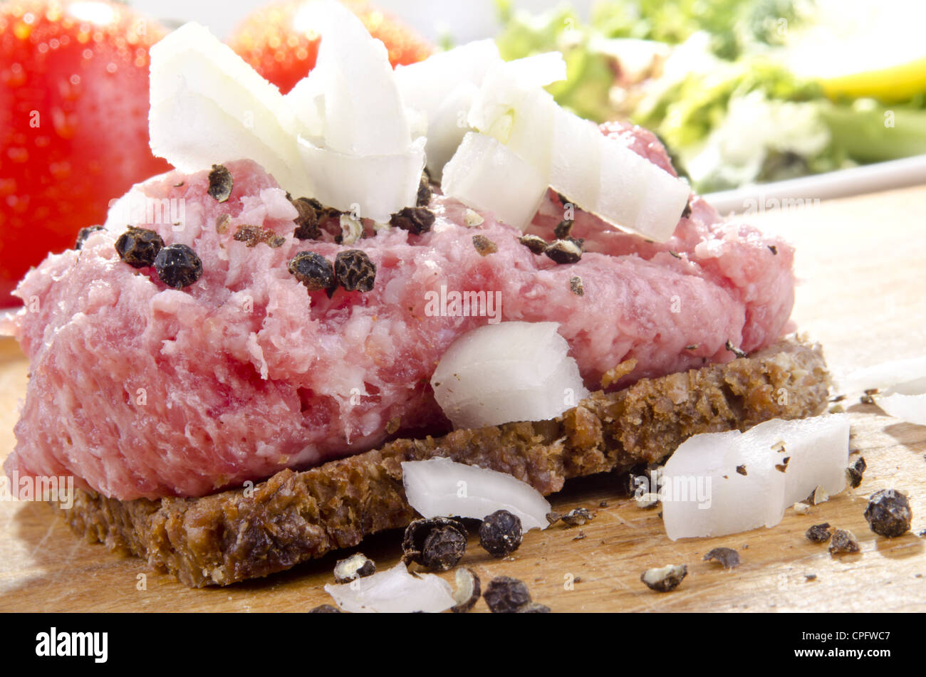 chopped pork meat without bacon with onion and pepper on rye bread Stock Photo