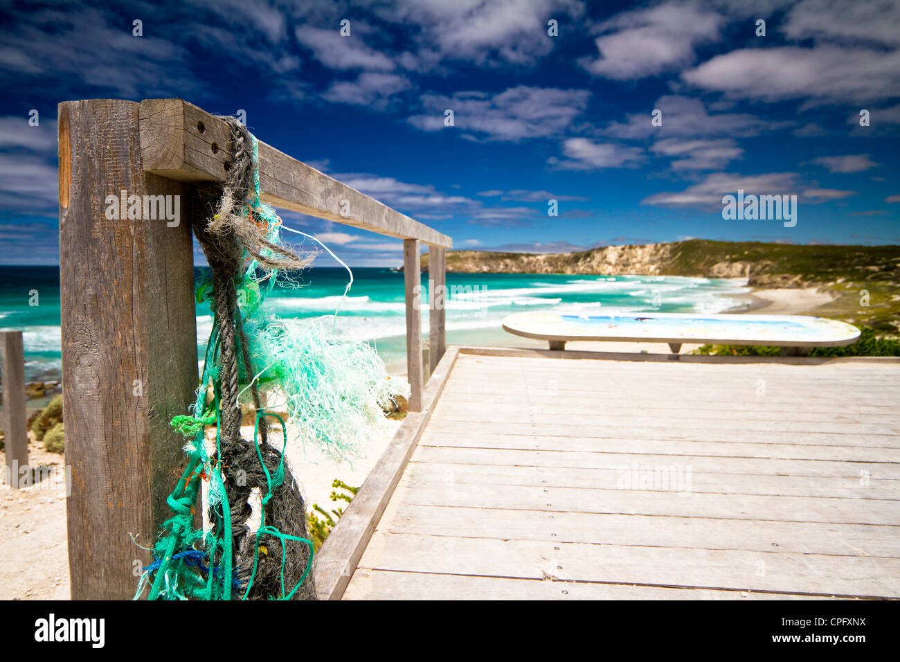 Used fishing nets, mesh and cords on a pontoon on the beach - Stock Image