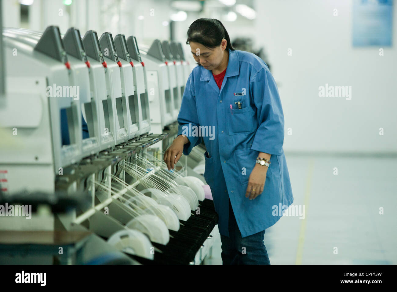 A worker on the assembly line at the Venture Corp. factory in Singapore Stock Photo