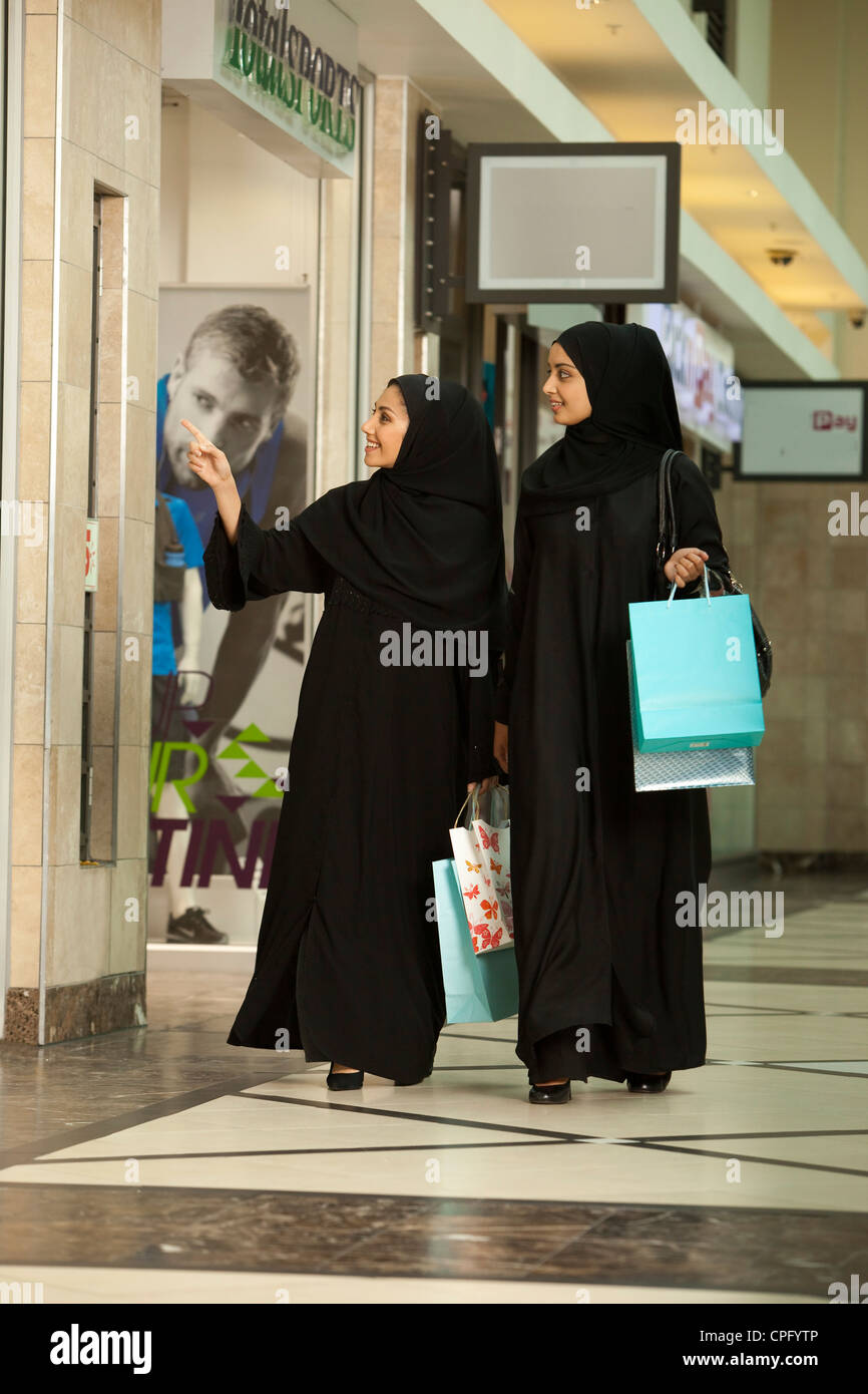 Two arab women with shopping bags walking at the mall Stock Photo - Alamy