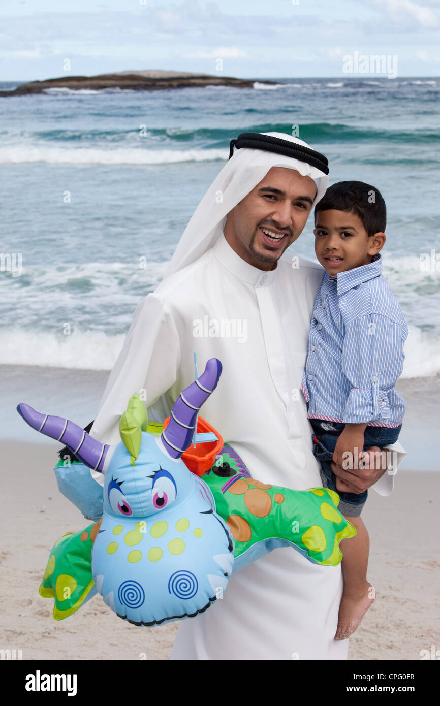 Arab father and son at the beach, smiling Stock Photo - Alamy