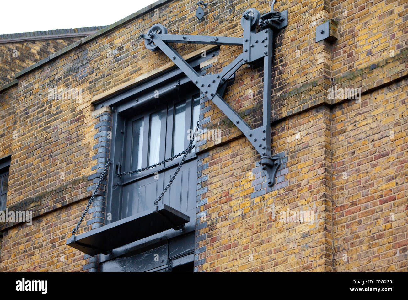 Old dock crane on wharf building, Wapping, London Stock Photo - Alamy