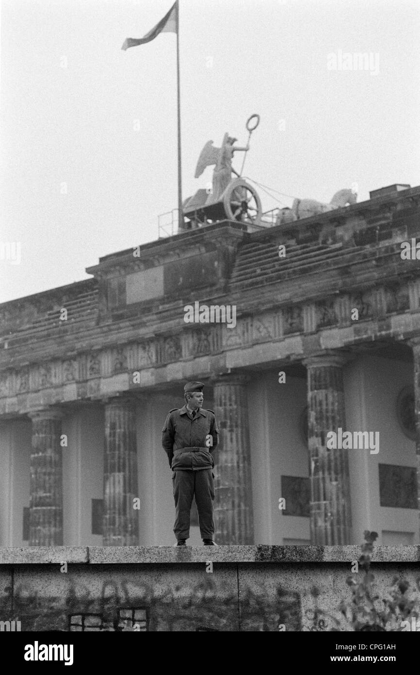 A border guard during the opening of the Berlin Wall at the Brandenburg