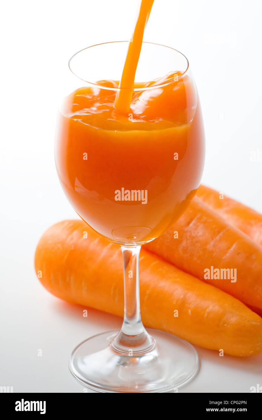 Juice In Goblet Alongside Carrot Stock Photo