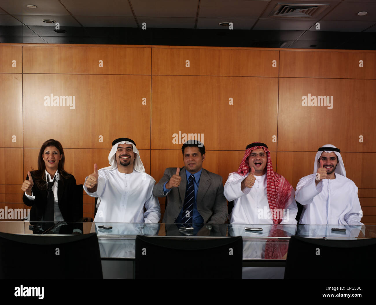 Businessmen sitting in a row with thumbs up Stock Photo - Alamy