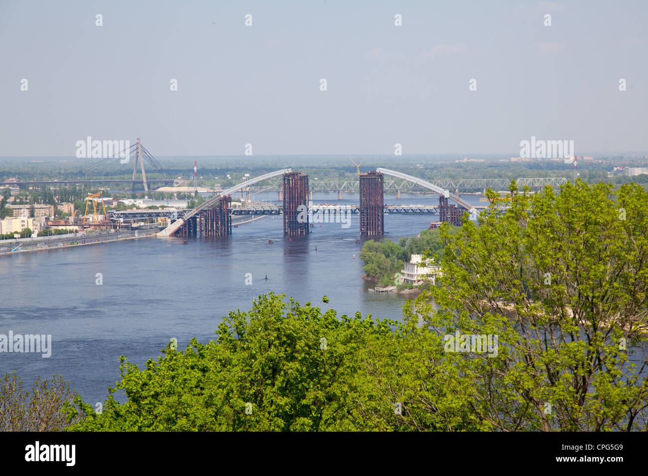 Kiev dnieper river and bridge throught trees Stock Photo