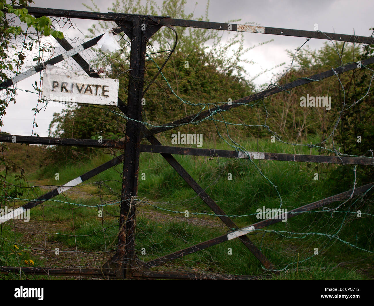 Gate with barbed wire, UK Stock Photo