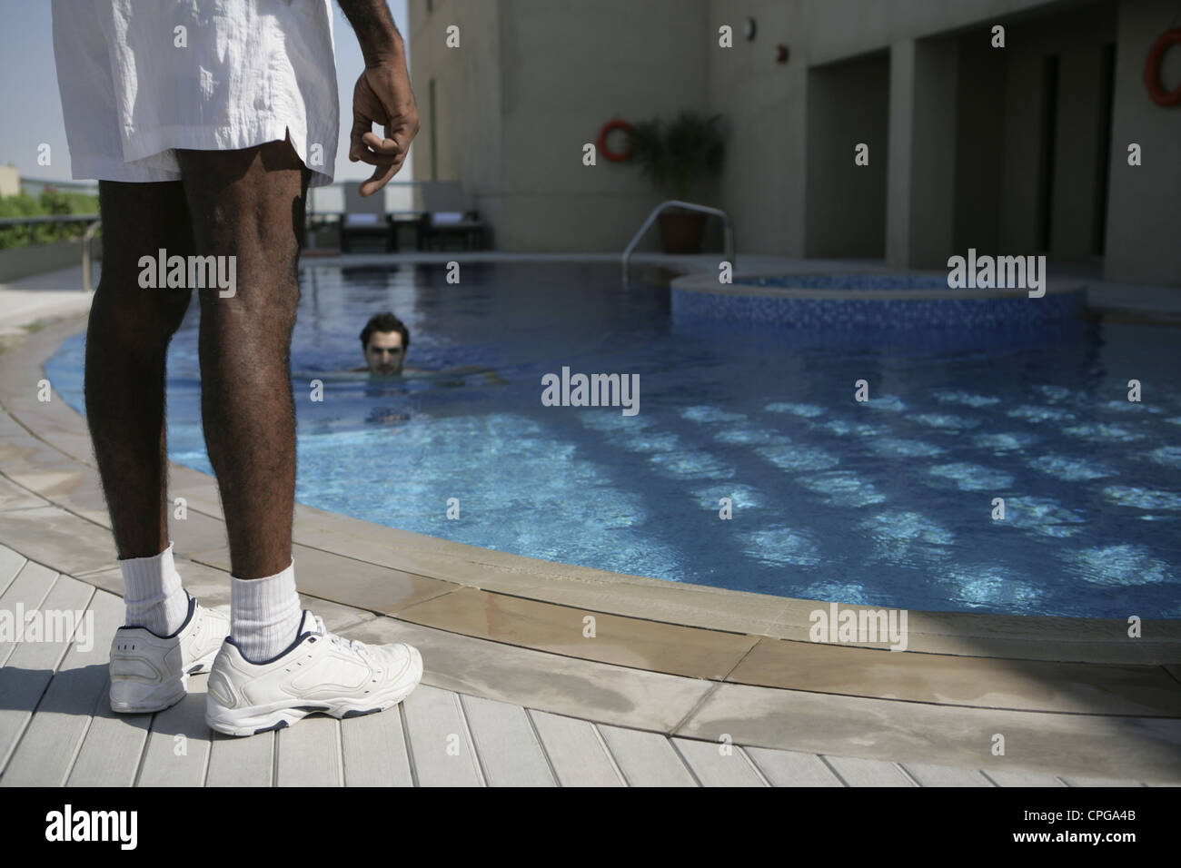 Guard standing beside the swimming pool Stock Photo - Alamy