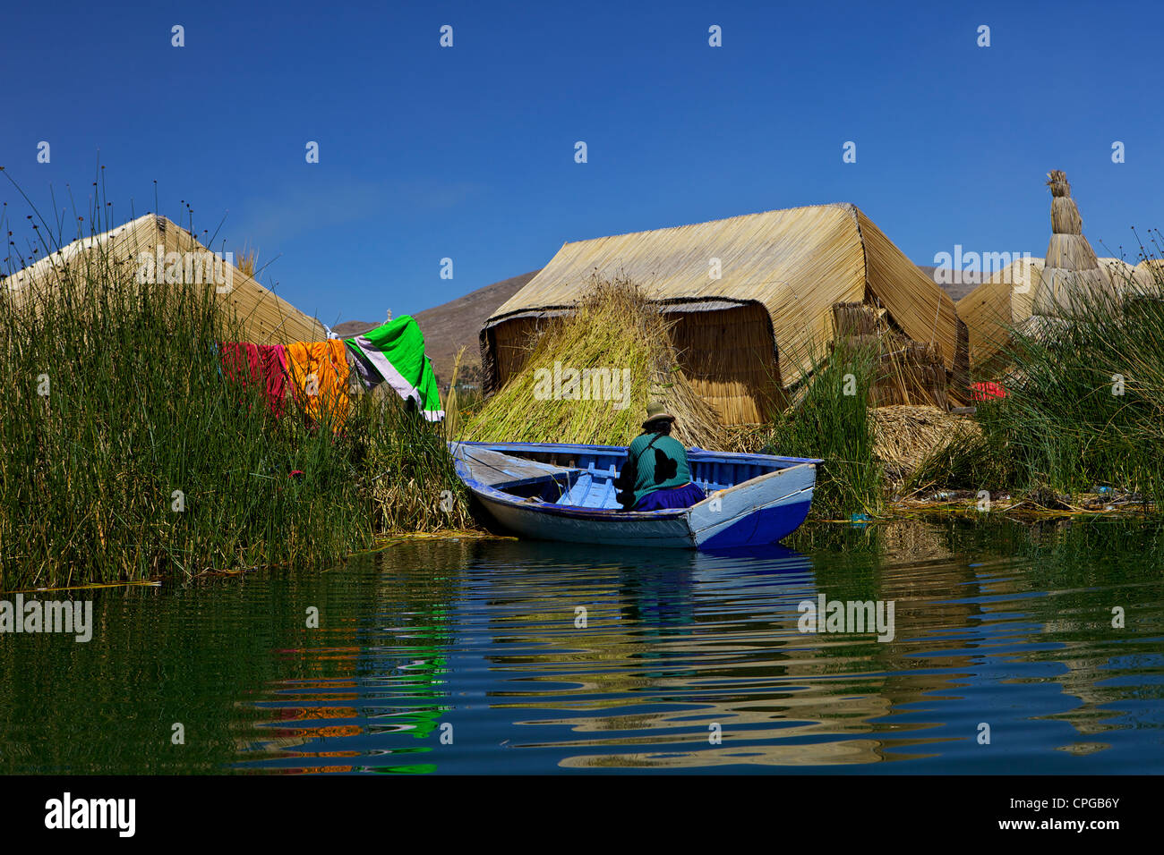 Floating islands, Uros, traditional aymara woman on boat with reed ...