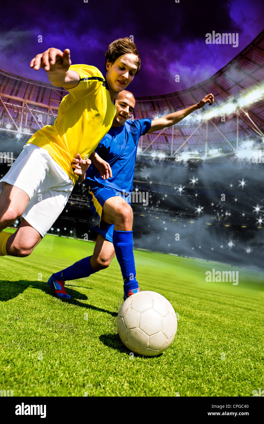 two football players from opposing team on the field Stock Photo