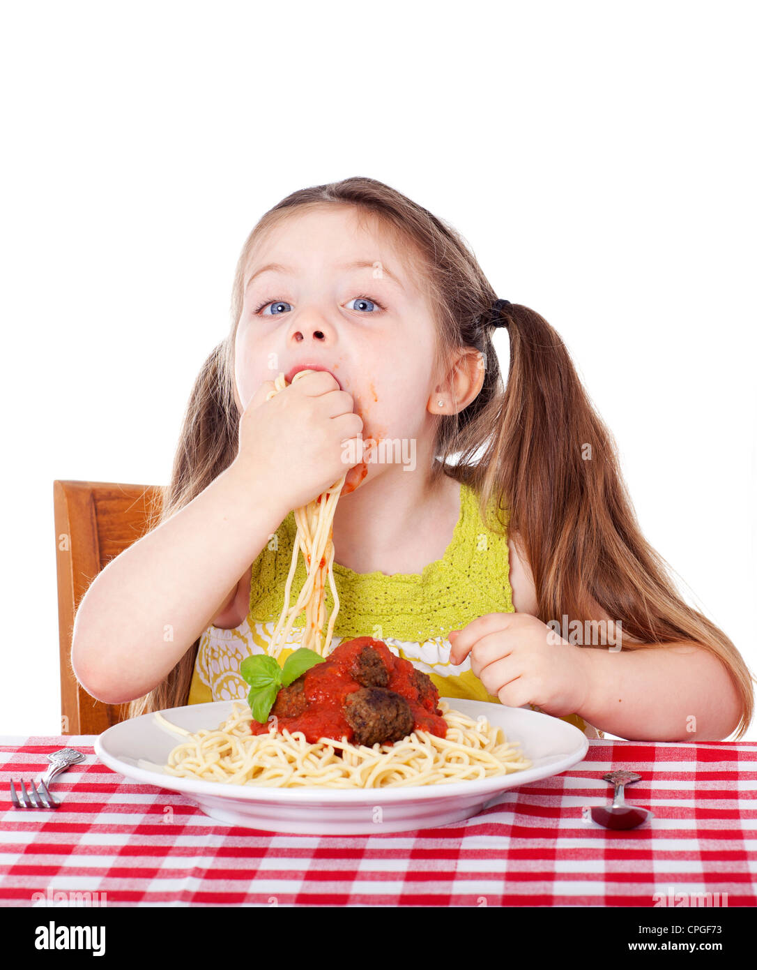 Beautiful girl eating pasta and meatballs with hands Stock Photo Alamy