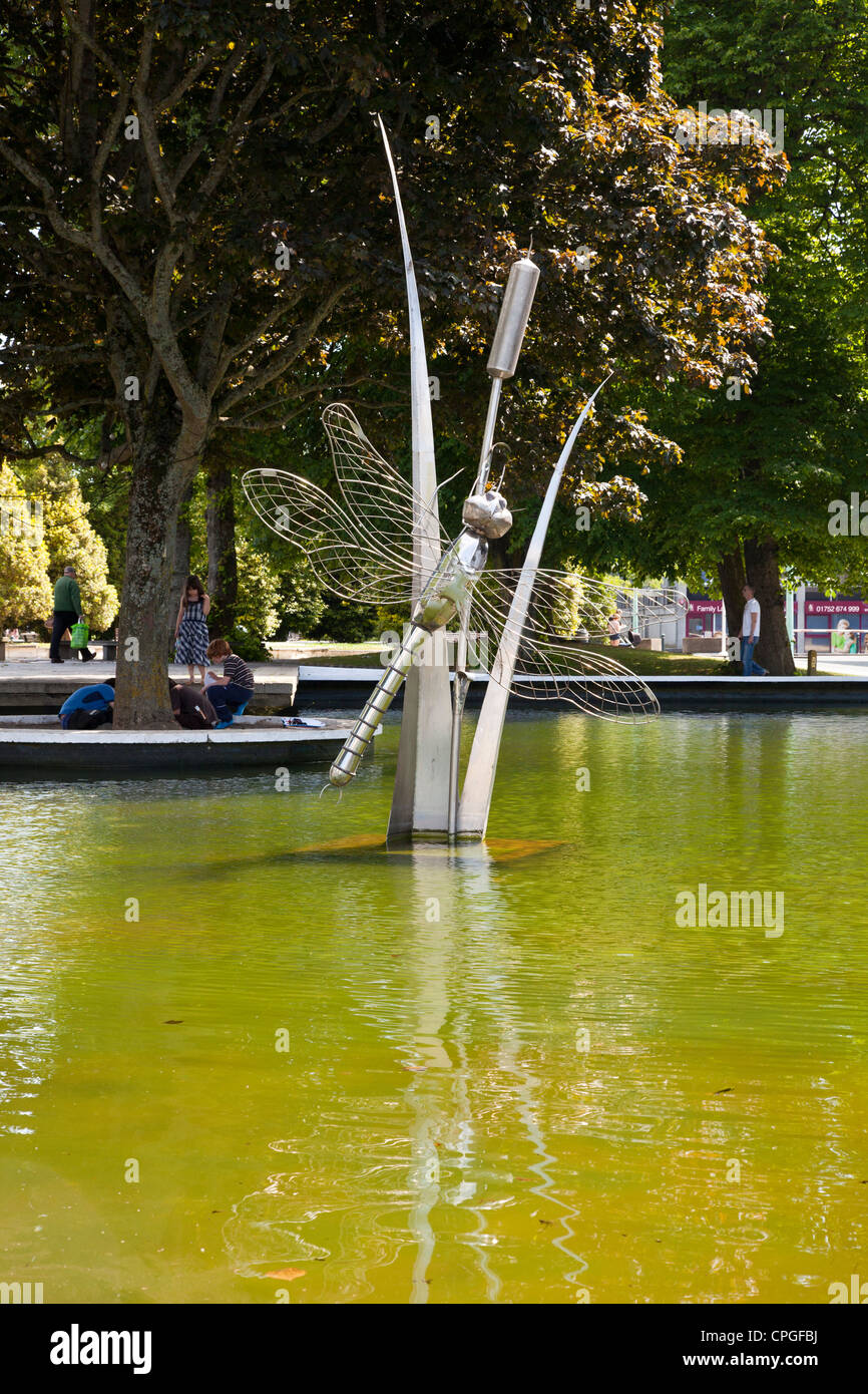 Dragon fly and bull rush stainless steel statue structure in water feature at Plymouth town center. Stock Photo