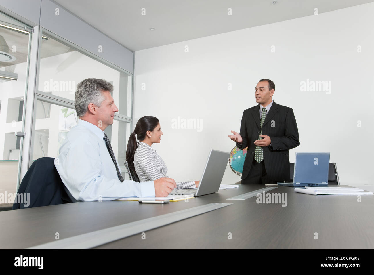 Three business people having meeting in office Stock Photo - Alamy