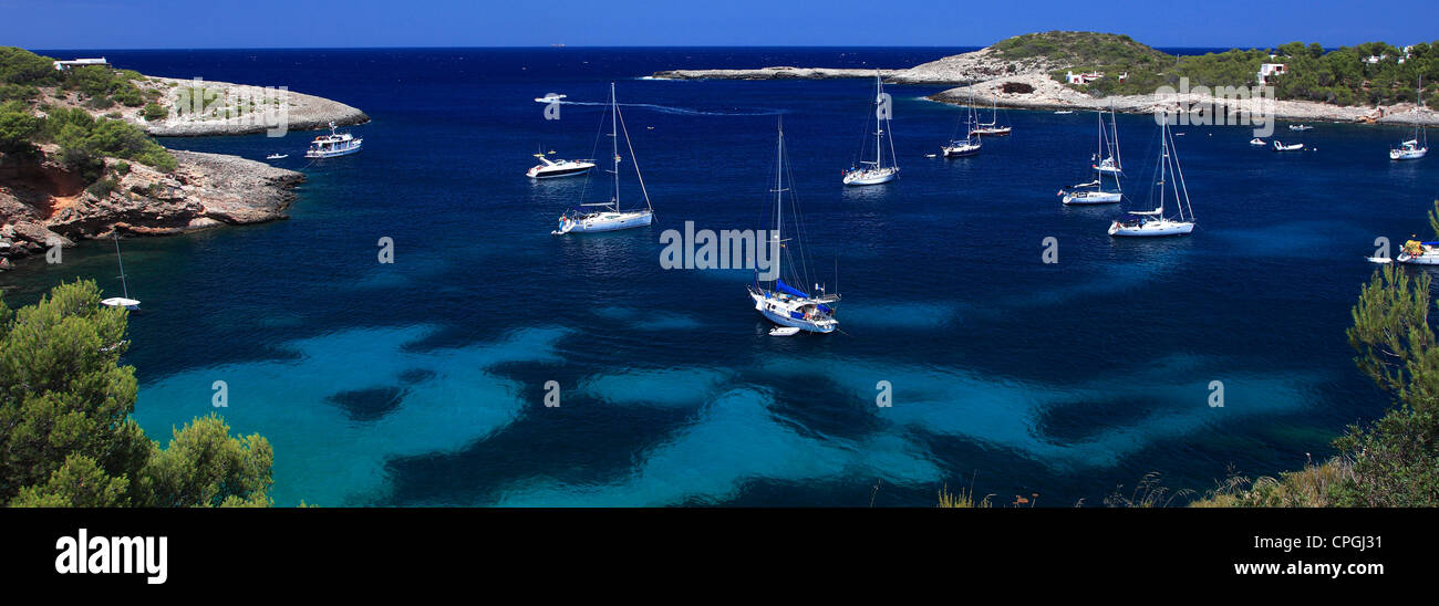 Tourist boats in the secluded bay at Cala Xarraca, Ibiza Island, Balearic Isles, Spain, Europe Stock Photo