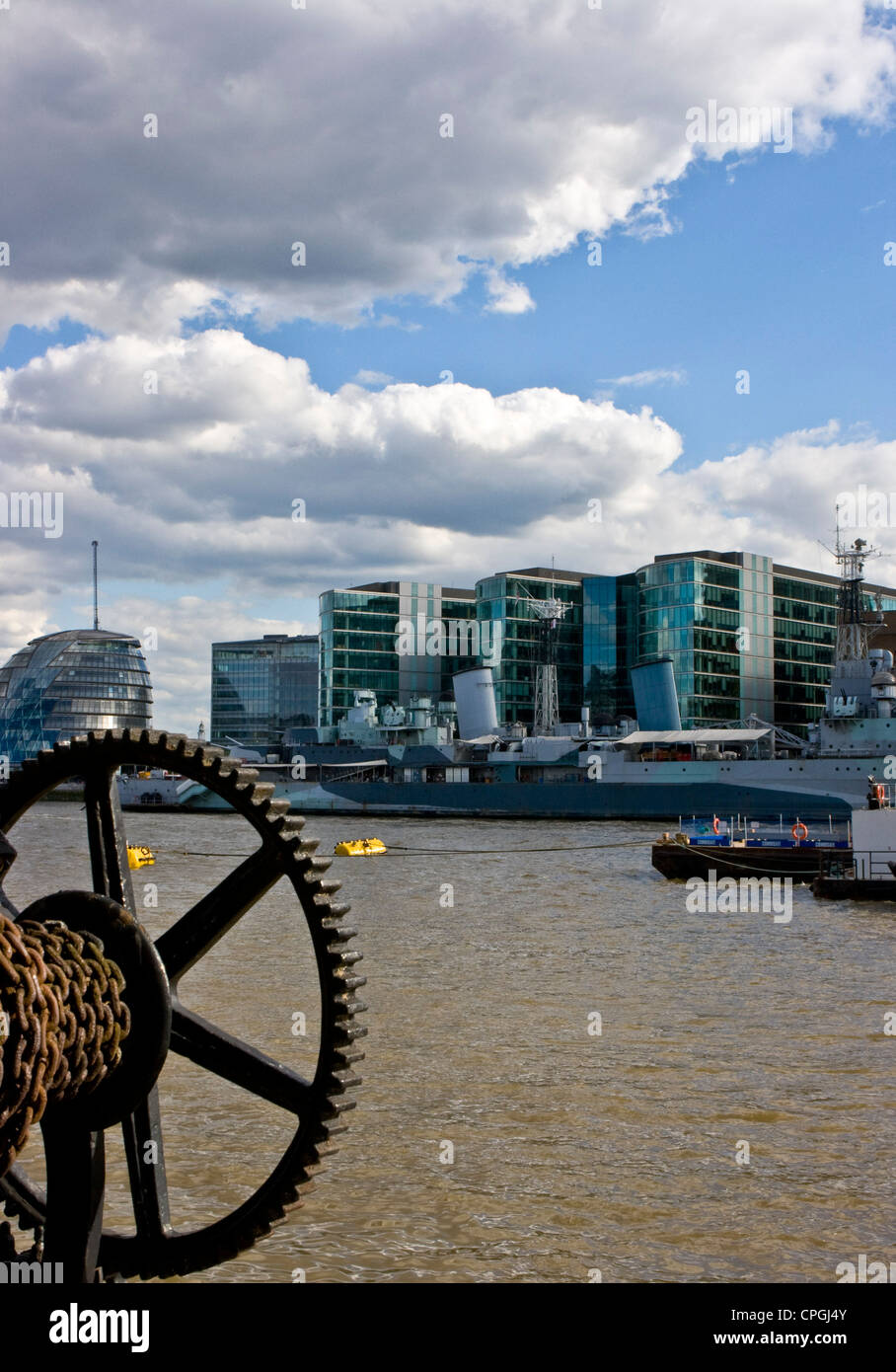 Panorama vista view from Thames path to South Bank with old chain winch City Hall and museum ship HMS Belfast London England Stock Photo
