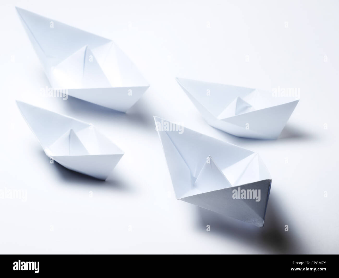 Several origami paperships on a clear background Stock Photo - Alamy