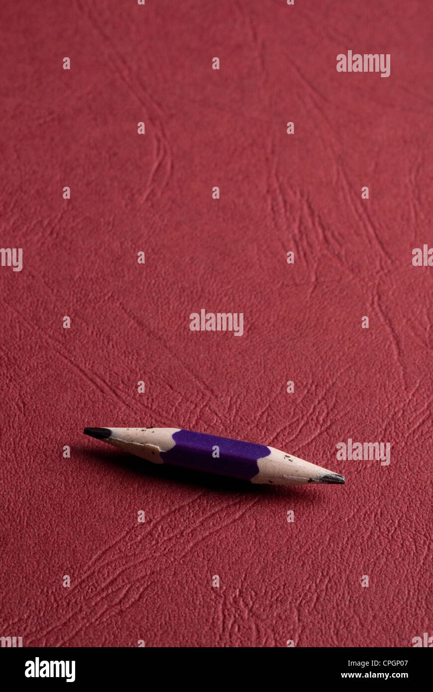 Pencil against red background Stock Photo