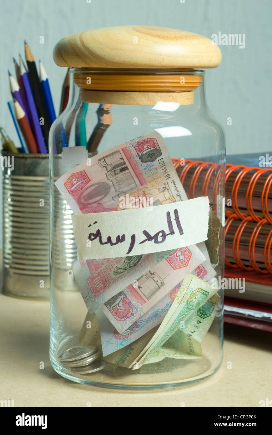 Money in container, close-up Stock Photo - Alamy