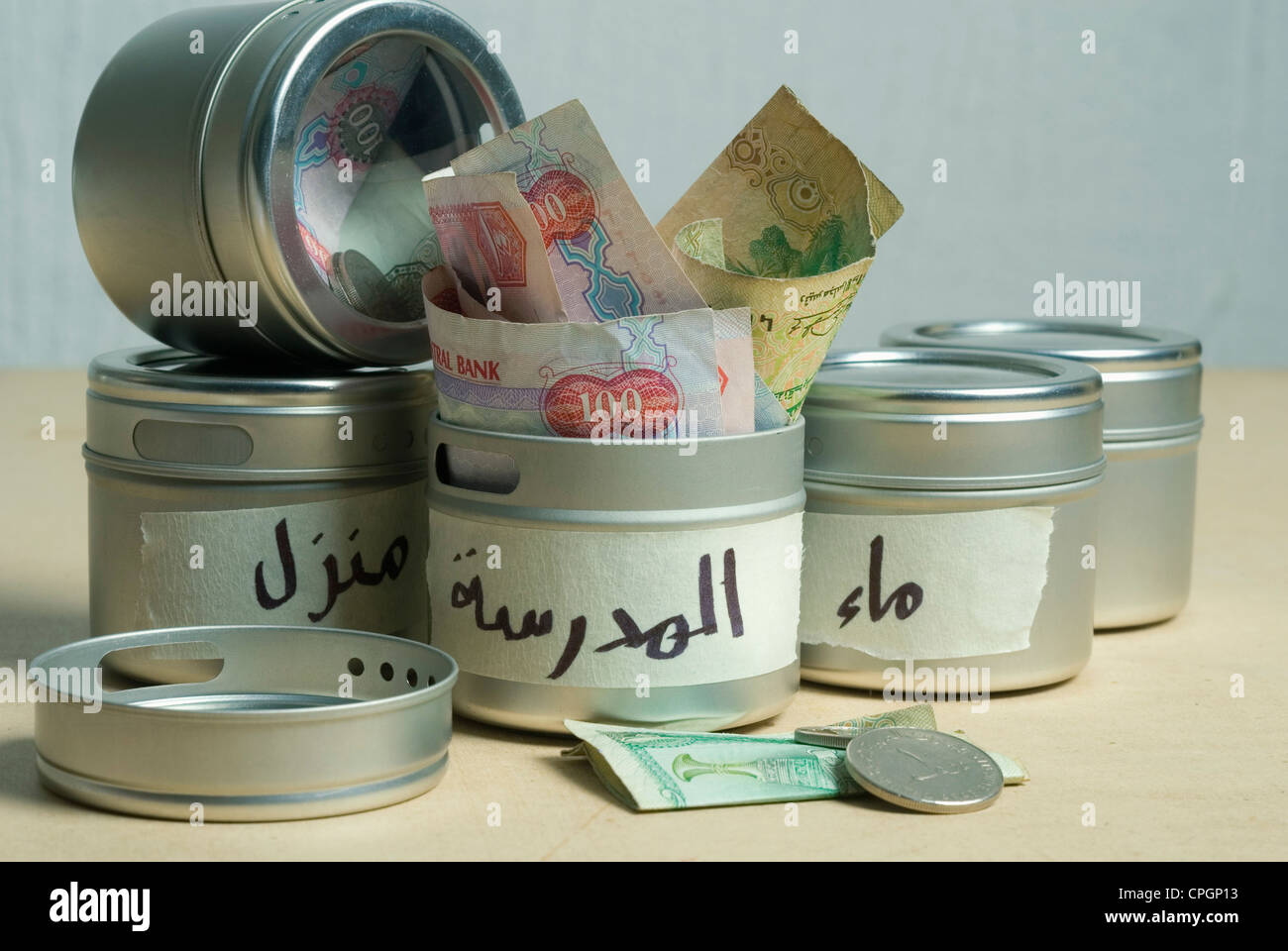 Money in containers, close-up Stock Photo - Alamy