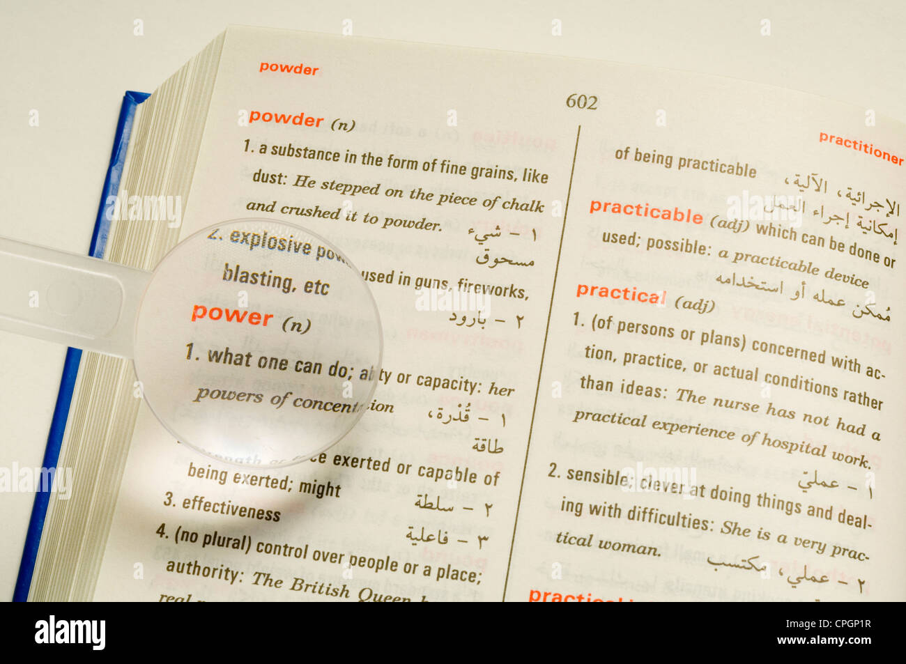 Magnifier on dictionary, closeup, elevated view Stock Photo Alamy