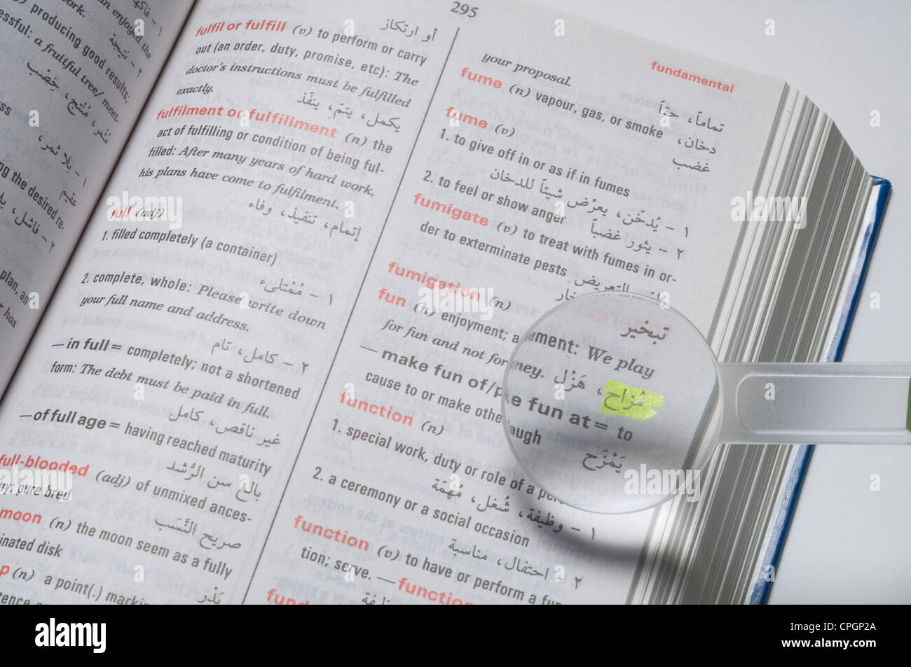 Magnifier on dictionary, closeup, elevated view Stock Photo Alamy