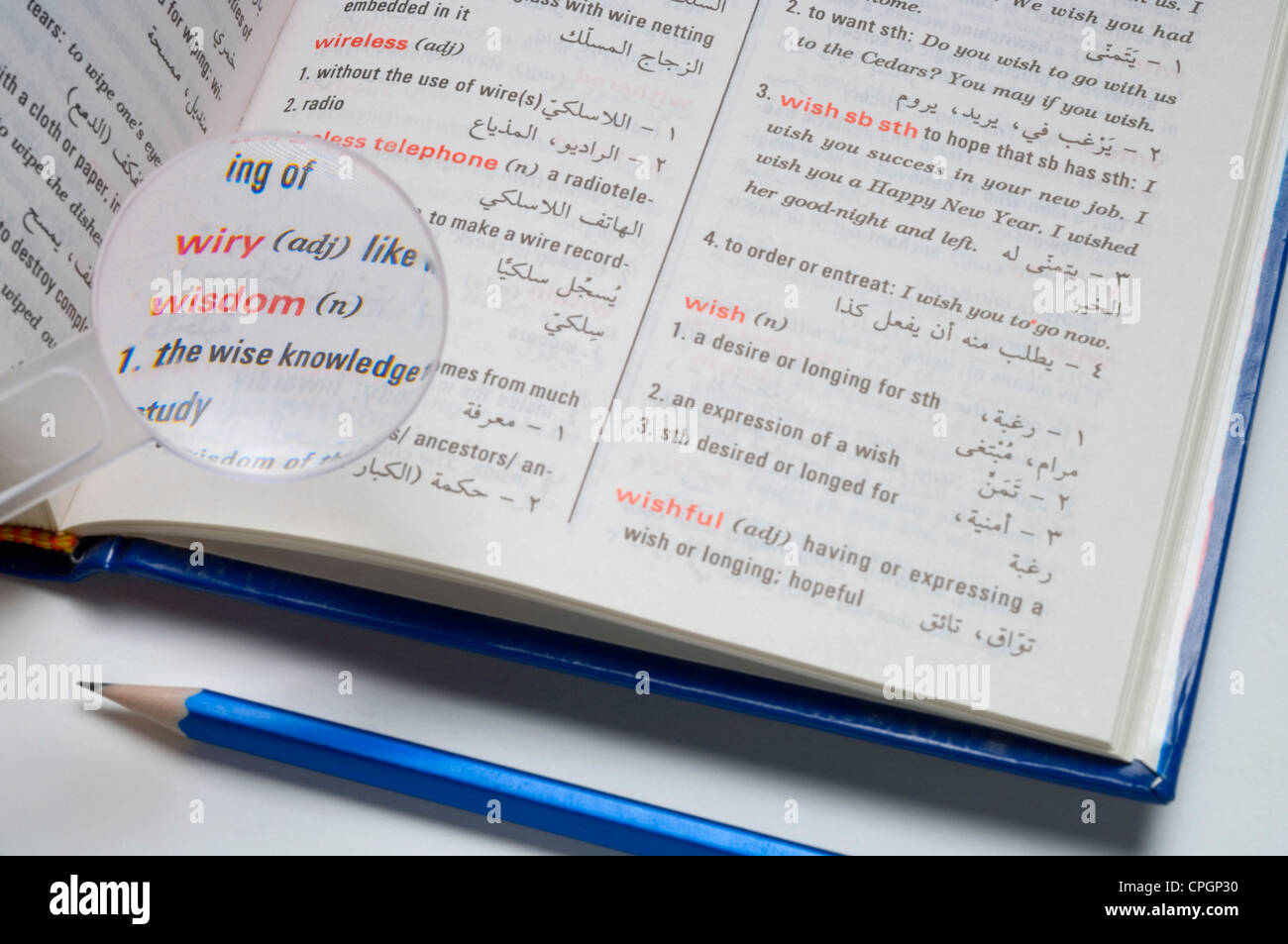 Magnifier on dictionary, closeup, elevated view Stock Photo Alamy