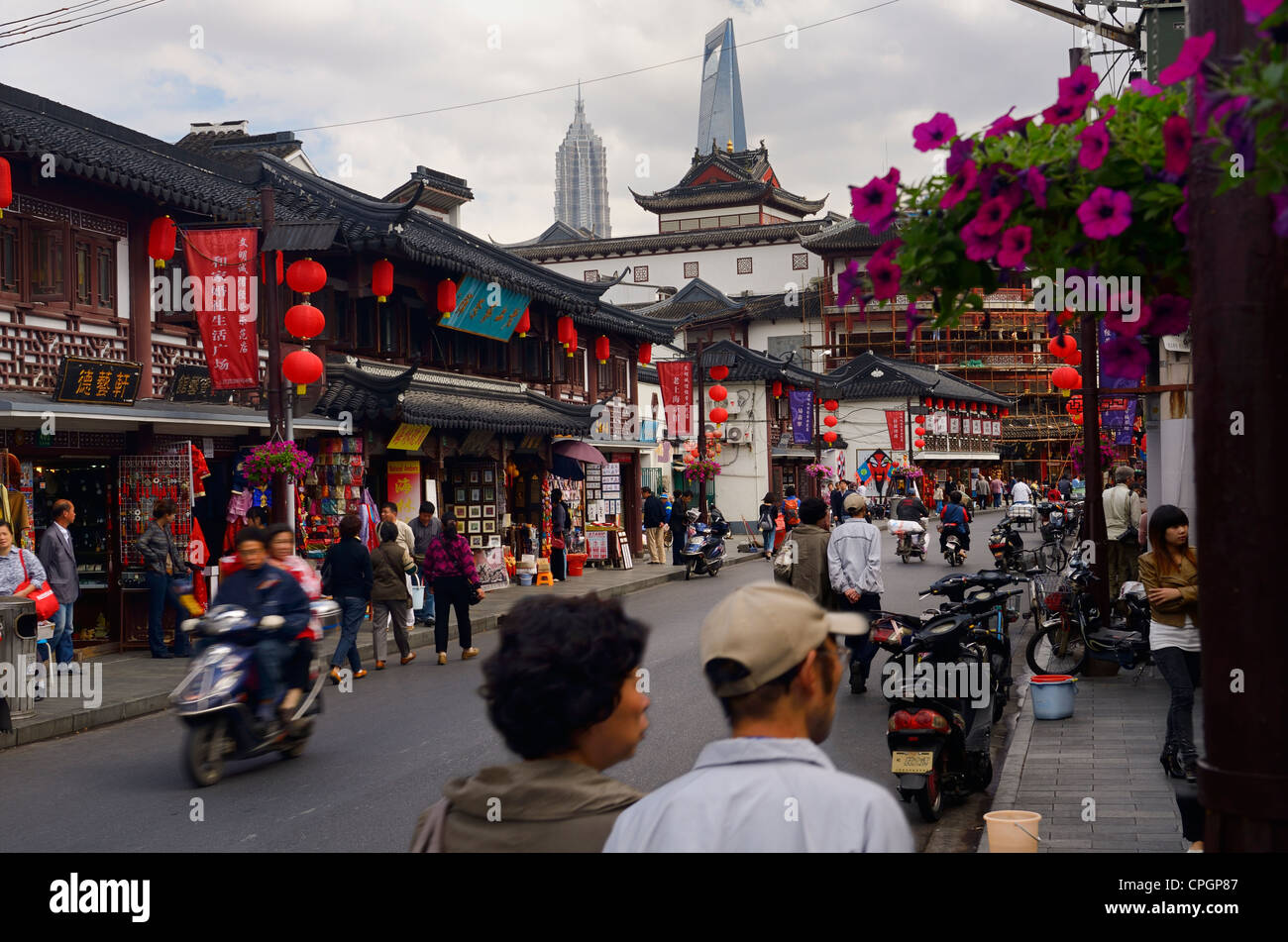 Fangbang Zhong road with shops pedestrians and motorcycles in Hangpu District Shanghai Peoples Republic of China Stock Photo