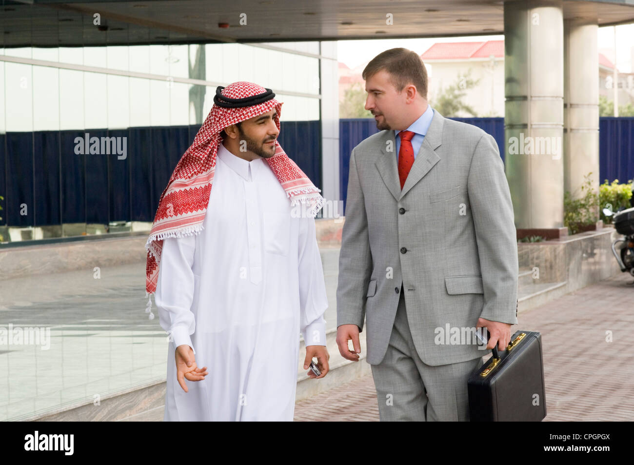 Businessmen looking at each other on sidewalk Stock Photo - Alamy