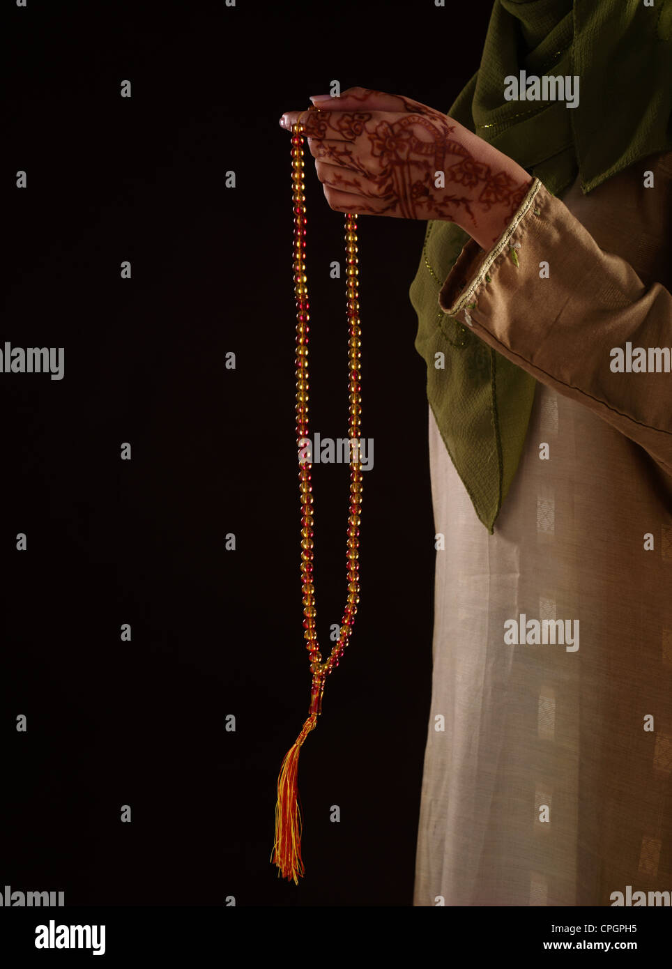 Human hand holding prayer beads, close-up Stock Photo