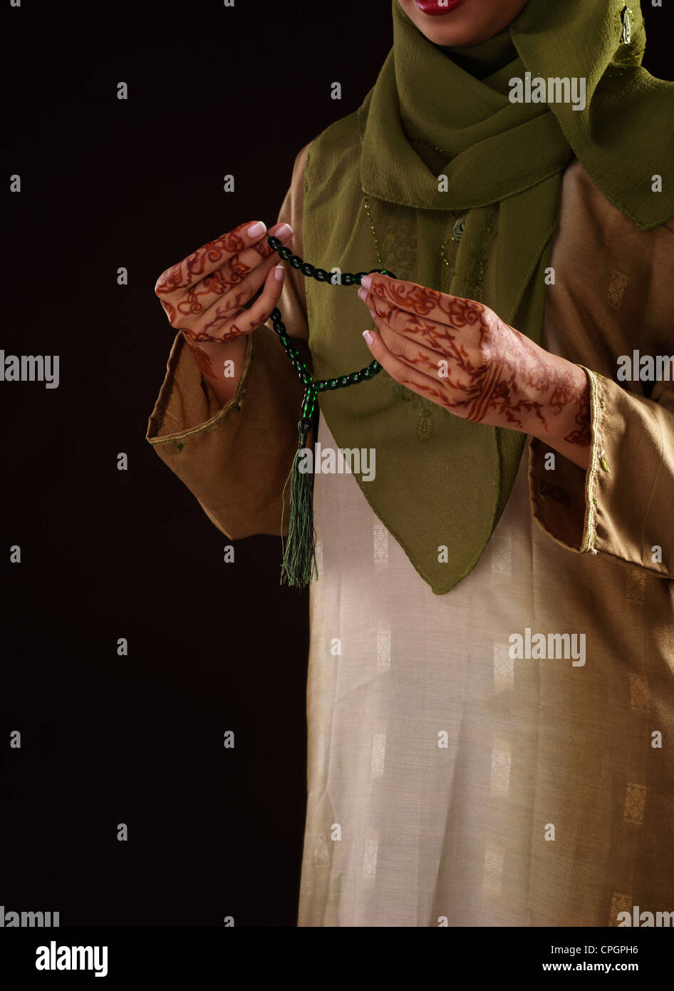 Young woman holding prayer beads, close-up Stock Photo