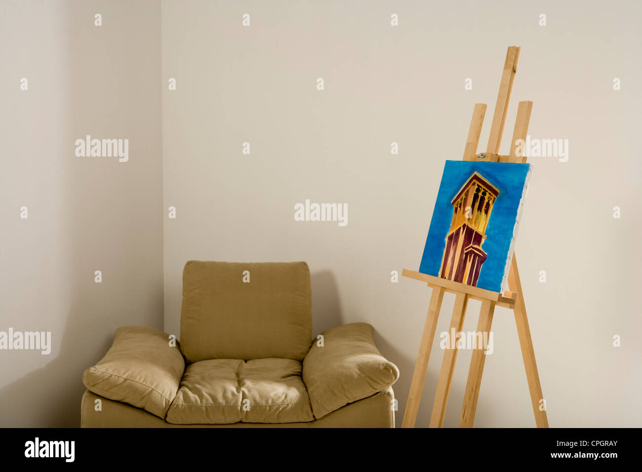 Easel with painting by chair Stock Photo Alamy