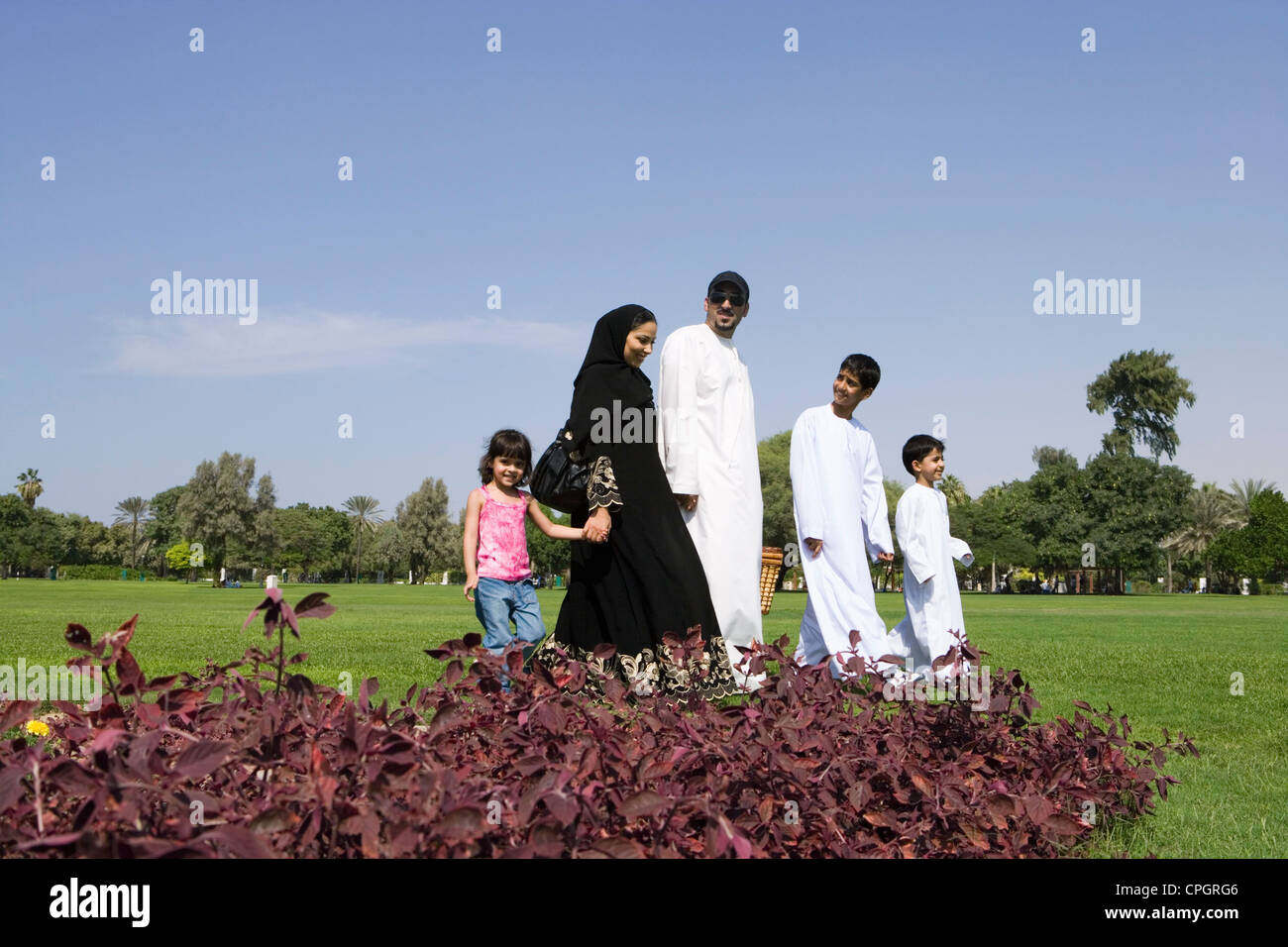 Father and mother with children at park Stock Photo