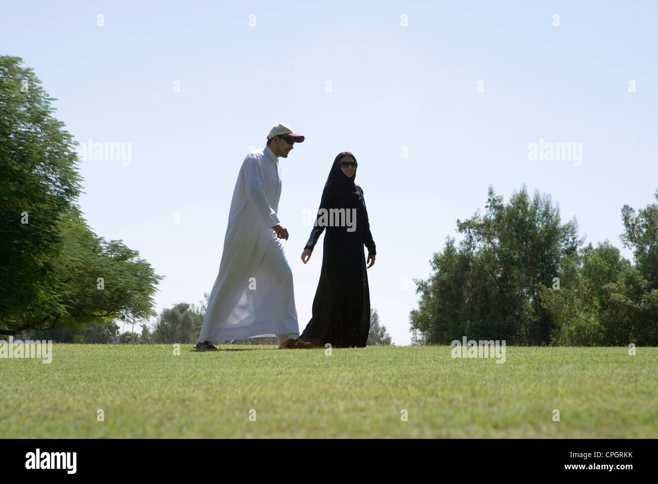 Young couple walking in park Stock Photo - Alamy