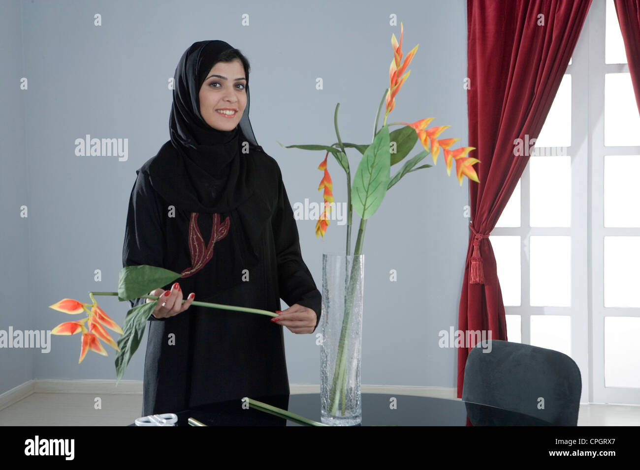 Arab woman arranging flowers in a vase Stock Photo Alamy
