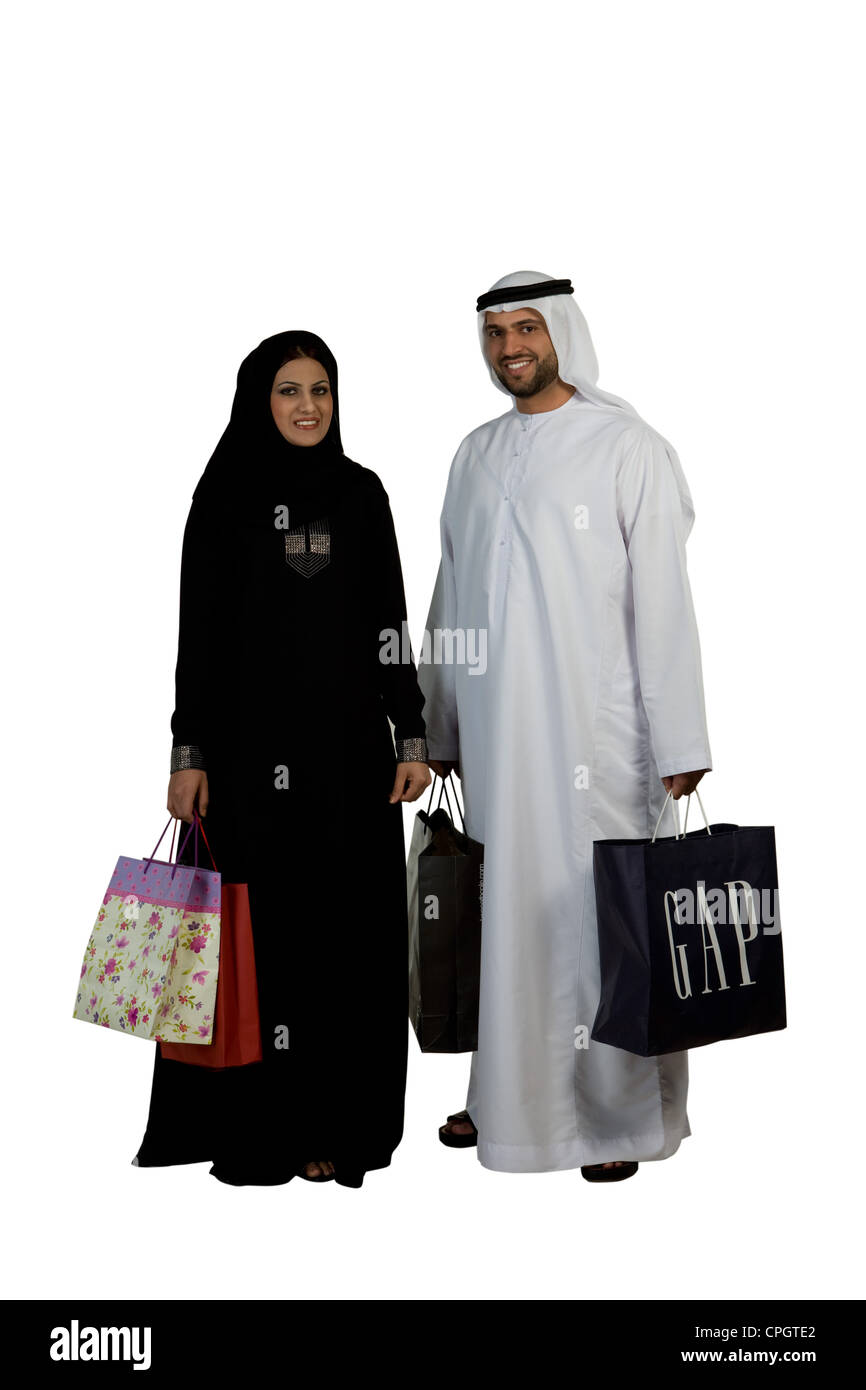Arab couple with shopping bags, smiling Stock Photo