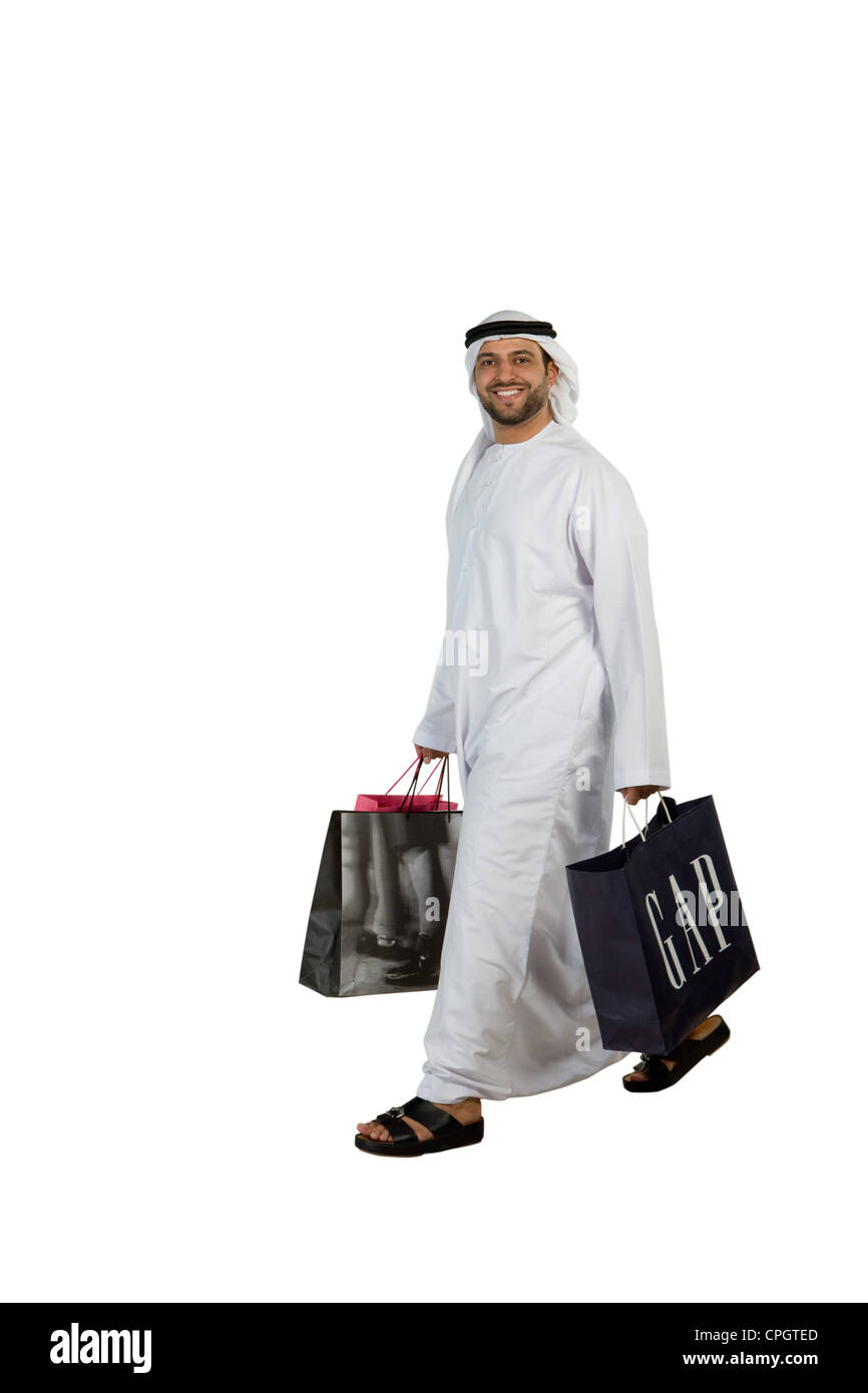 Arab man with shopping bags walking Stock Photo