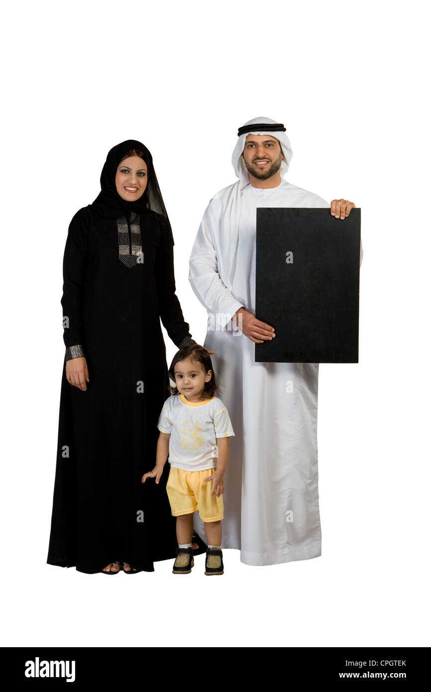 Arab family with placard, smiling, looking at the camera Stock Photo