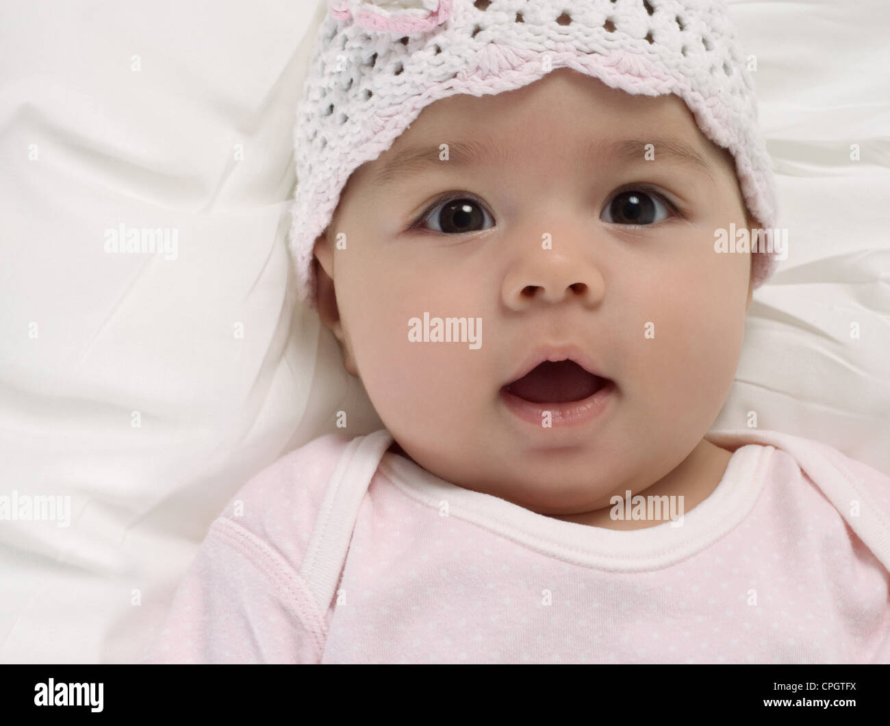Baby girl lying on the bed Stock Photo Alamy
