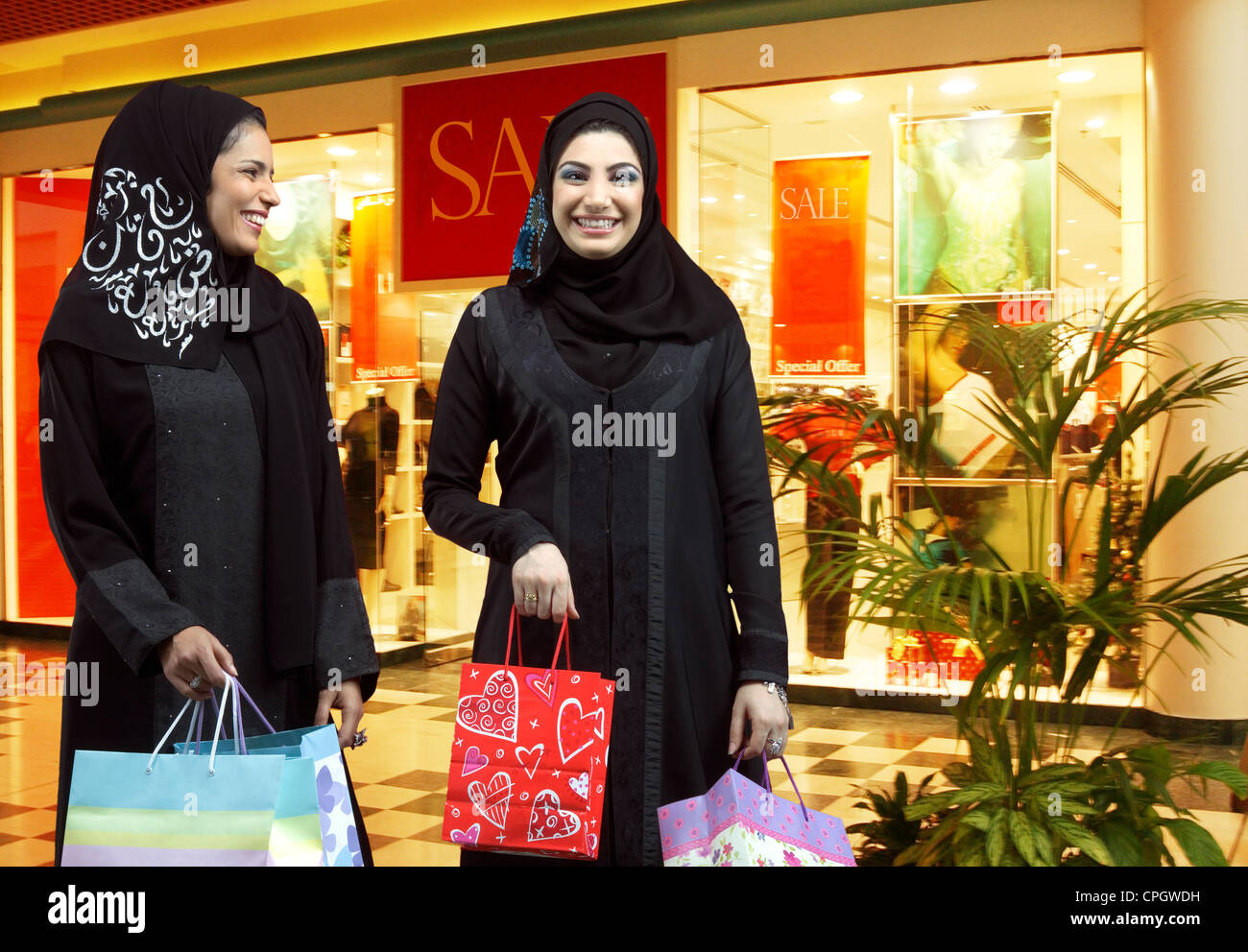 Two Arab Ladies with shopping bags Stock Photo - Alamy