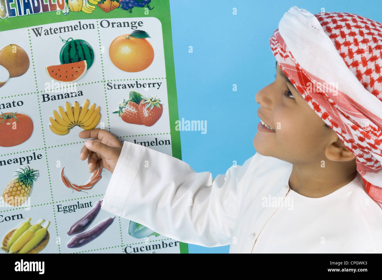 Arab boy learning the names of fruits Stock Photo